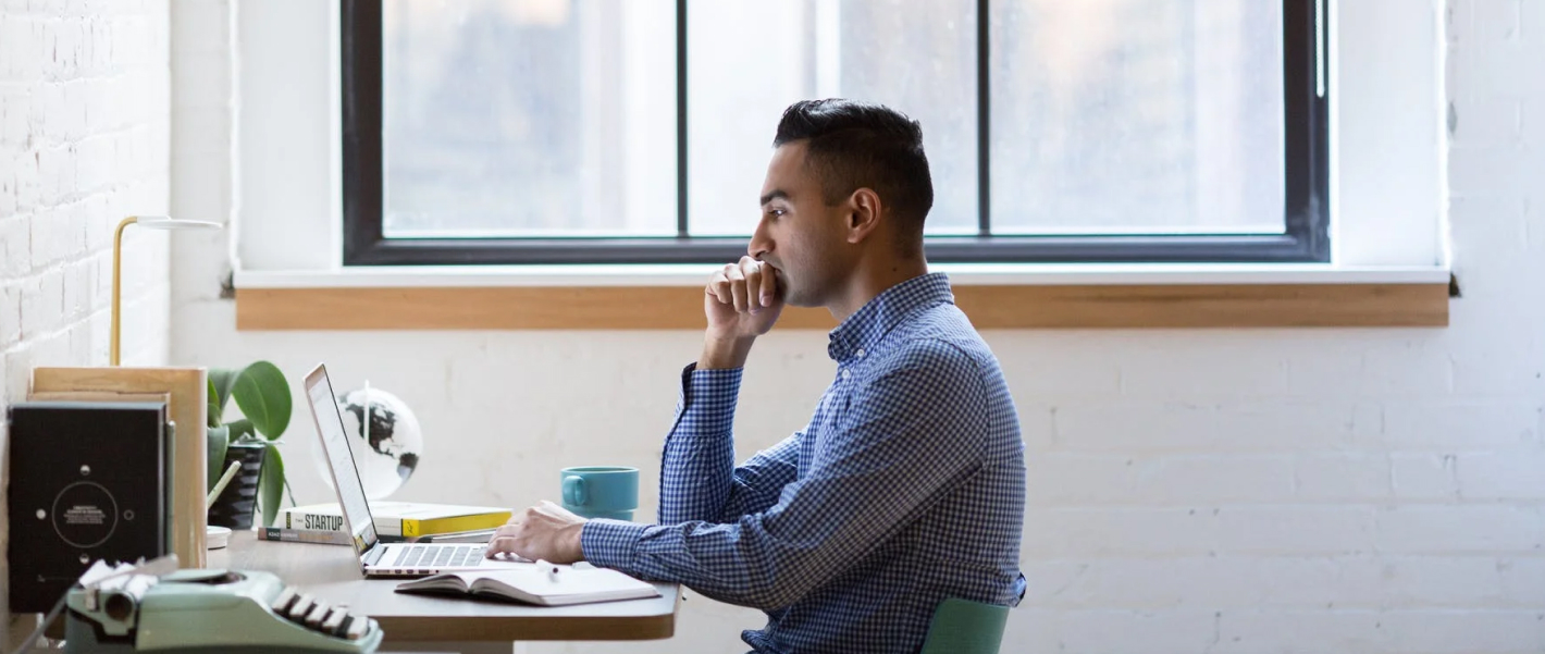 a man is working seriously in an office setting